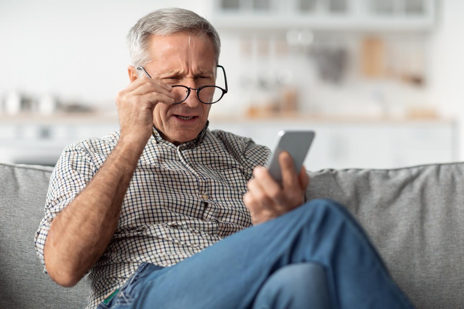 Man with glasses experiencing eye strain